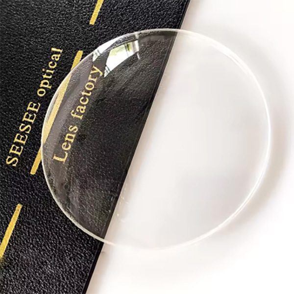 A clear mineral glass single vision lens on a dark cloth embroidered Seesee optical lens factory