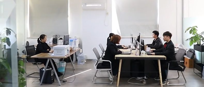 Staff working at desks in a white office